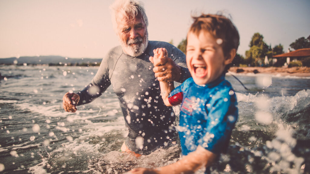 Man and boy playing in the sea